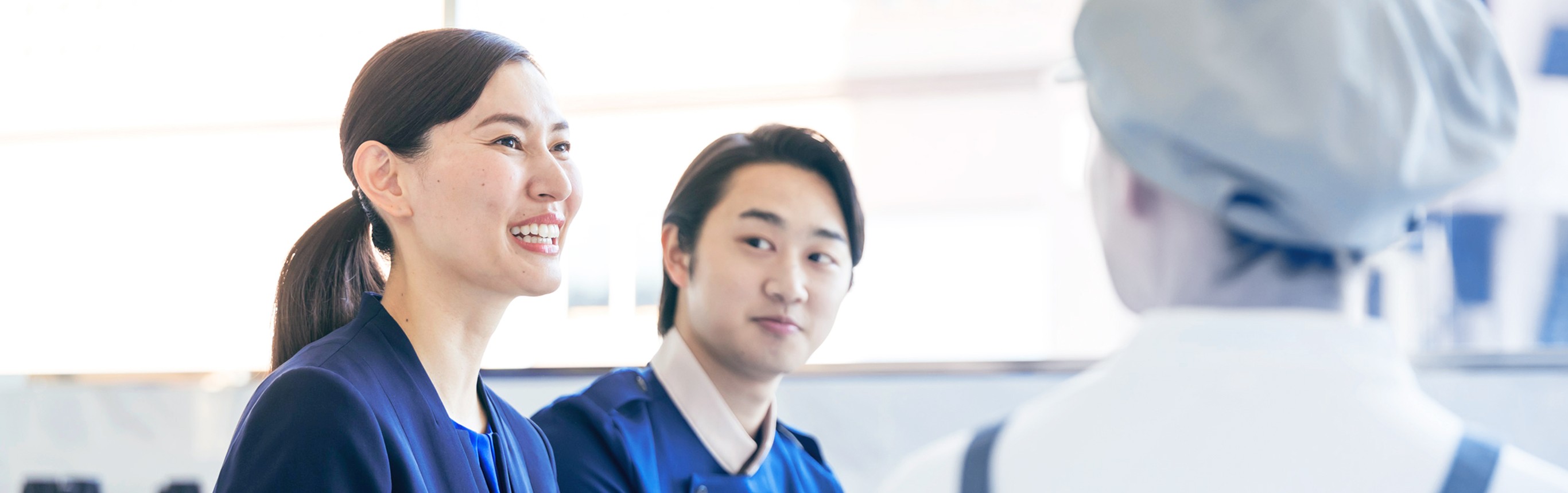 ホテルスタッフと笑顔で会話する支配人の女性